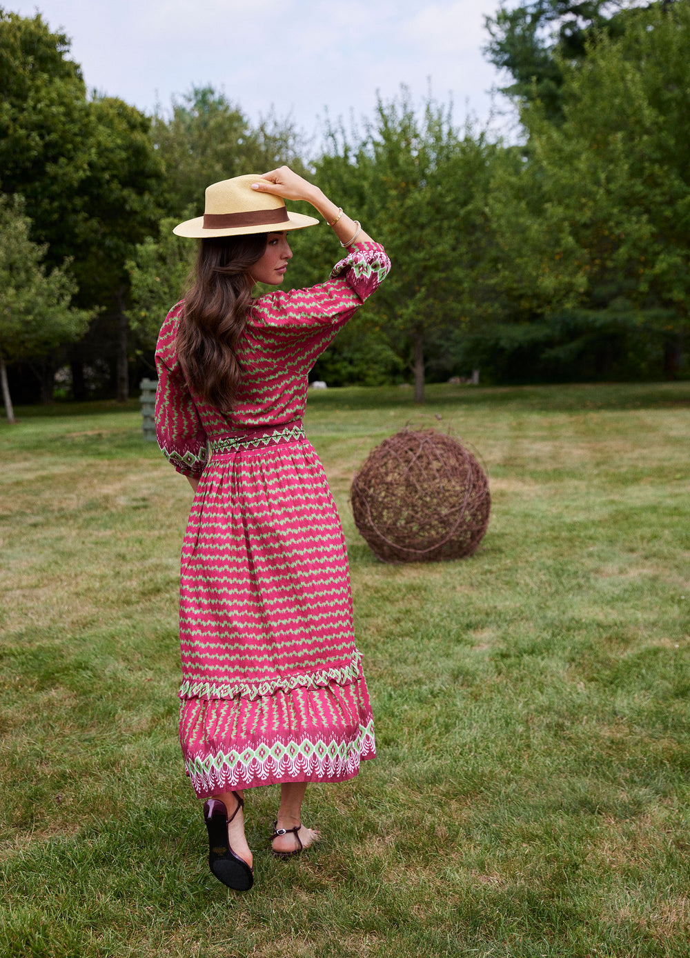 Elsa Dress in Ikat Stripe Cranberry, back view on a lawn