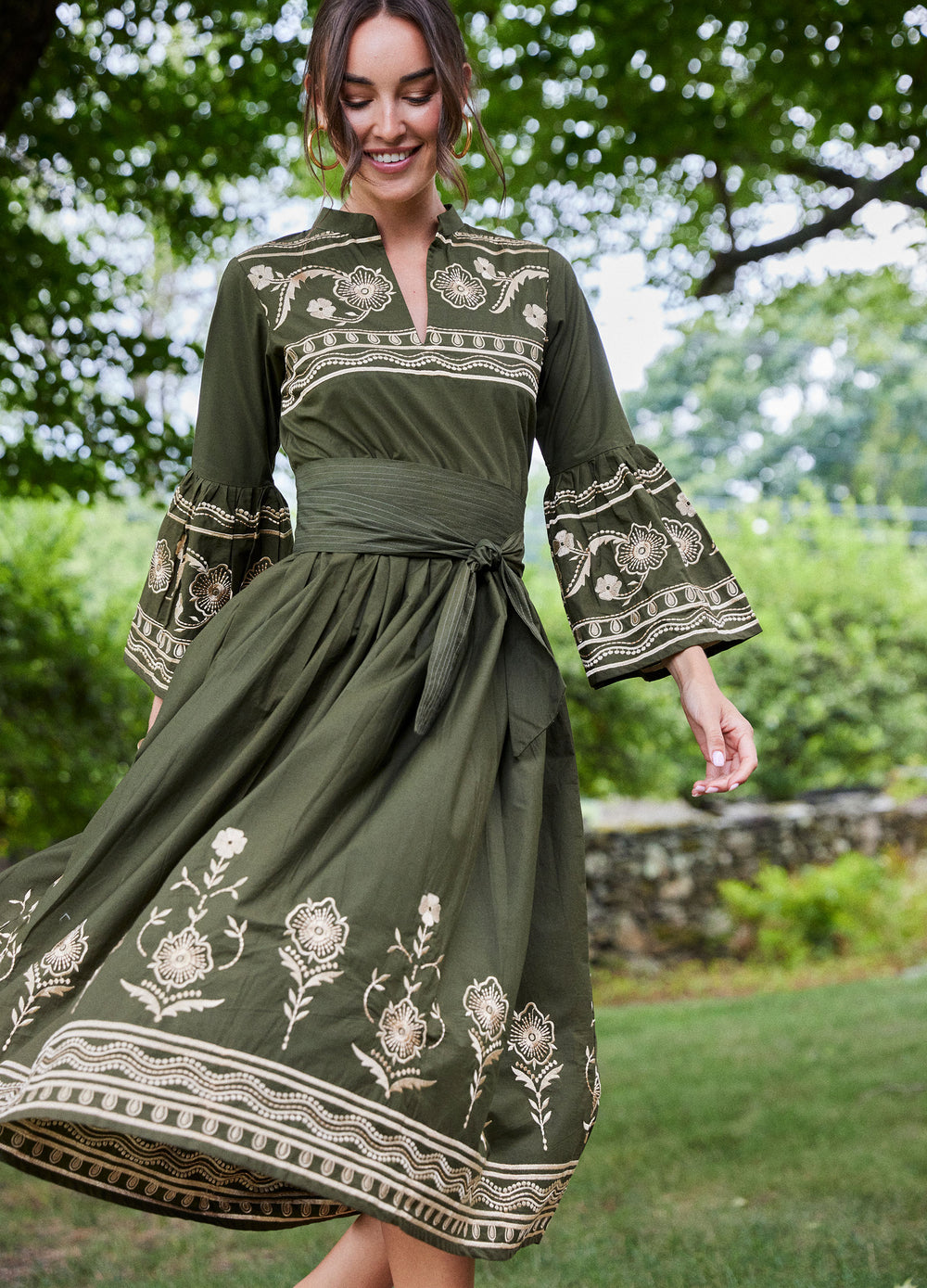 Elena Dress in Loden Green, skirt in motion in a garden