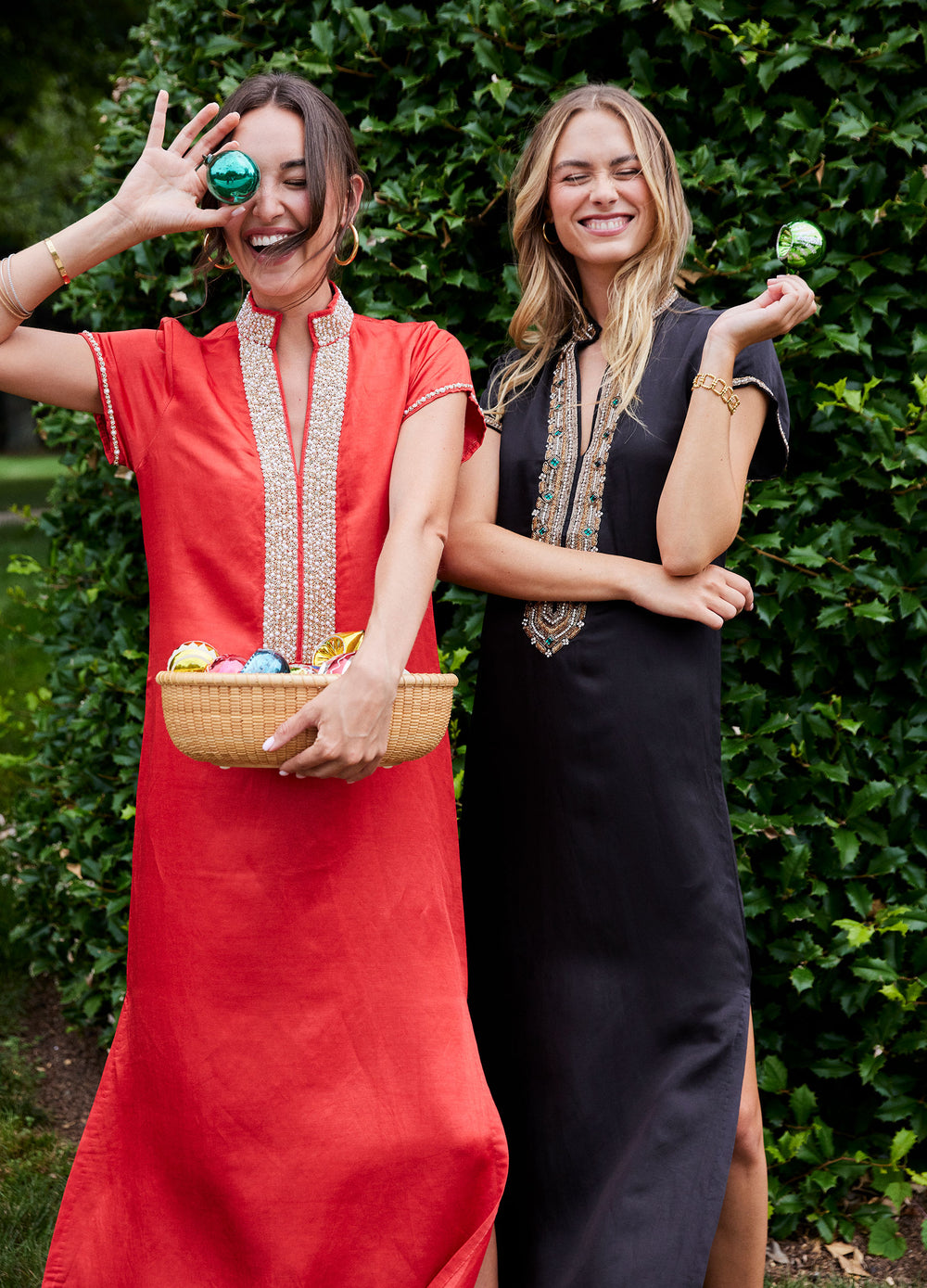Hayden Caftan in Black, by a hedge, beside a second caftan