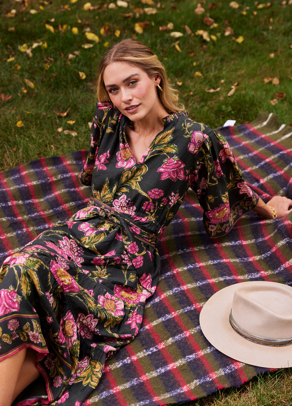Becca Dress in Lila Pink, lying on a picnic blanket
