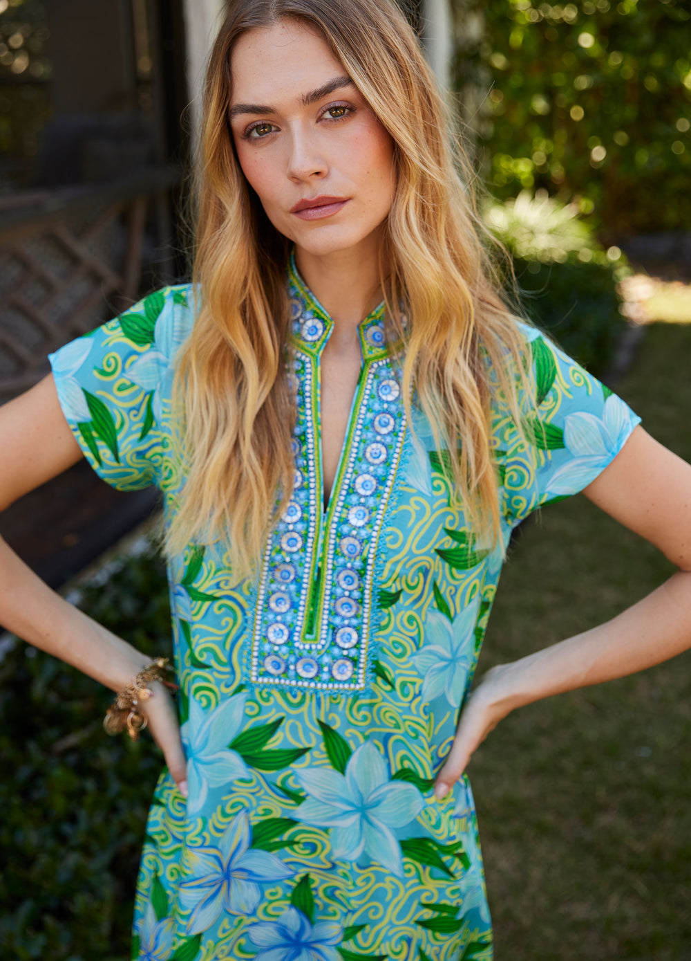 Lana Cap Sleeve Caftan in Maui Blue, closer view in a garden, hands on hips