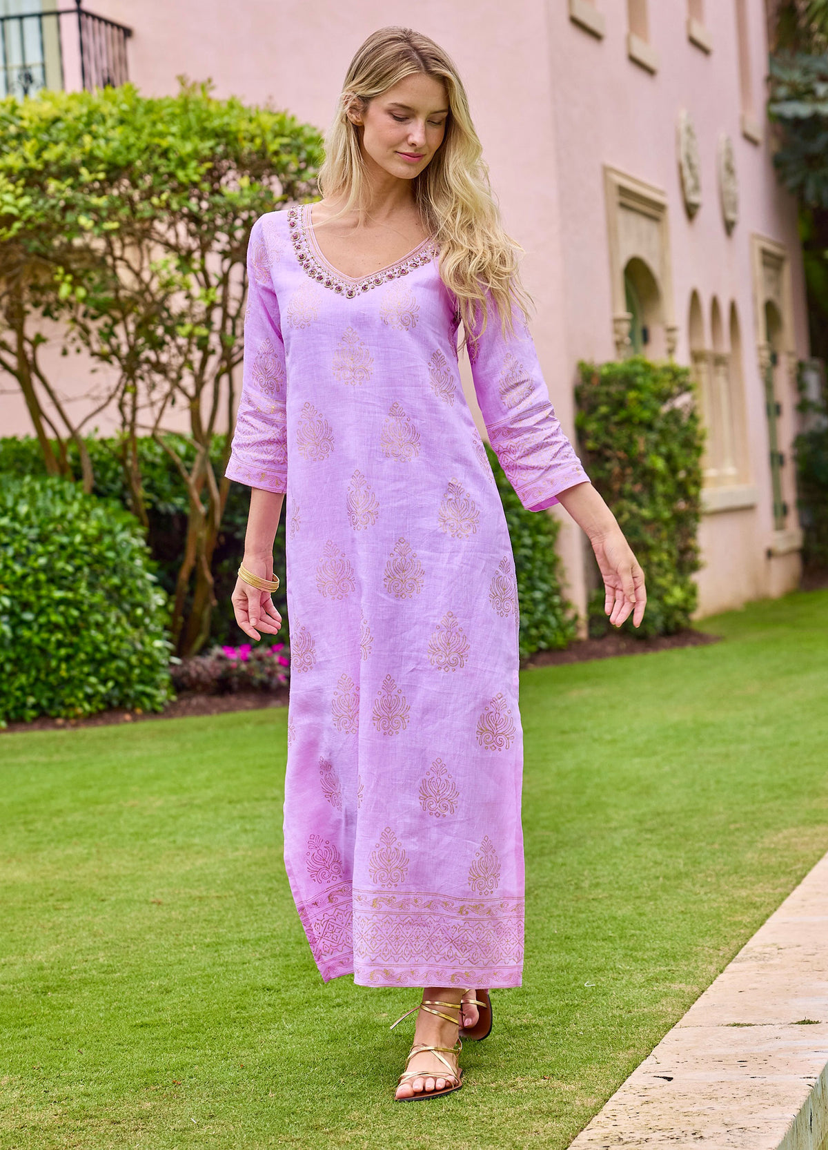 Rani Caftan in Pink, walking on a lawn