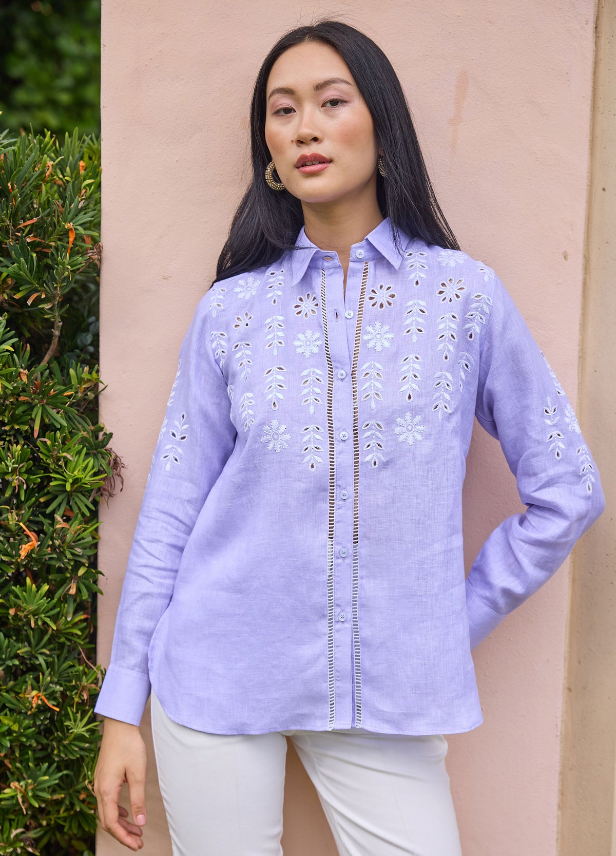 Aster Shirt in Lilac, front view by a garden wall