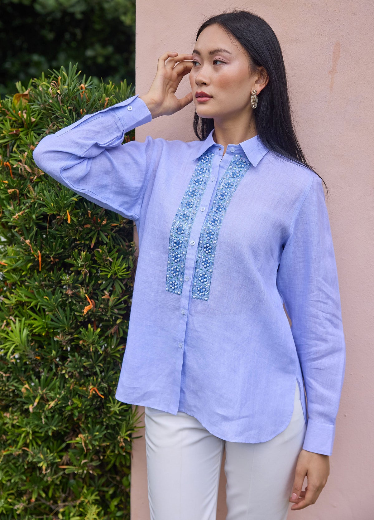 Pearl Flower Shirt in Blue, front view by a garden wall