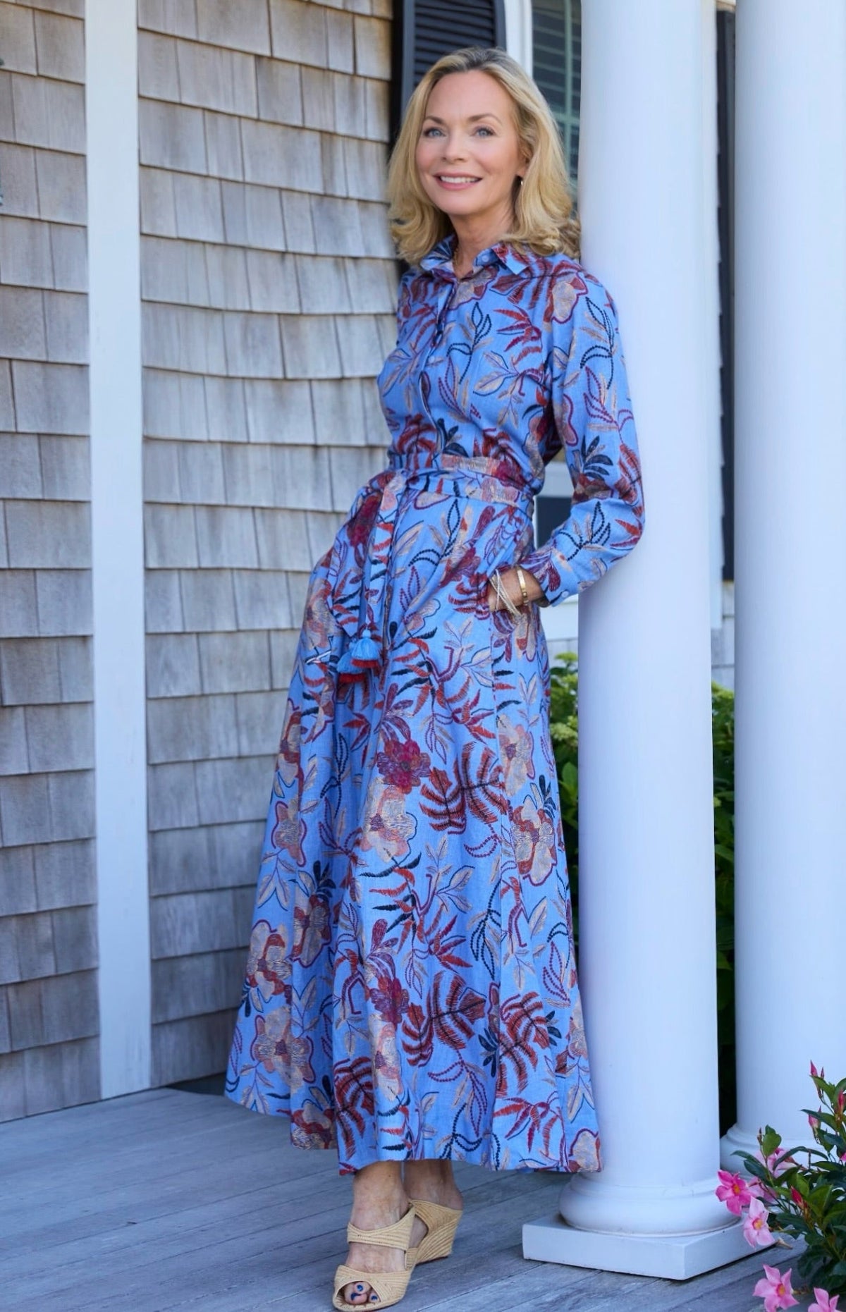 Jeanne Daniel on a porch in a blue floral bella tu shirtdress